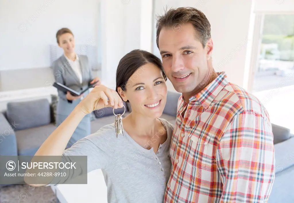 Portrait of smiling couple holding house keys