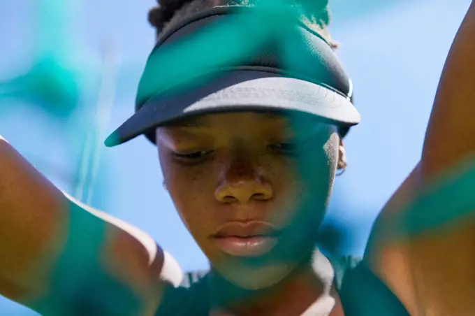 Close up determined female track and field athlete in visor