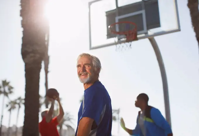 Los Angeles, USA, Older men playing basketball on court