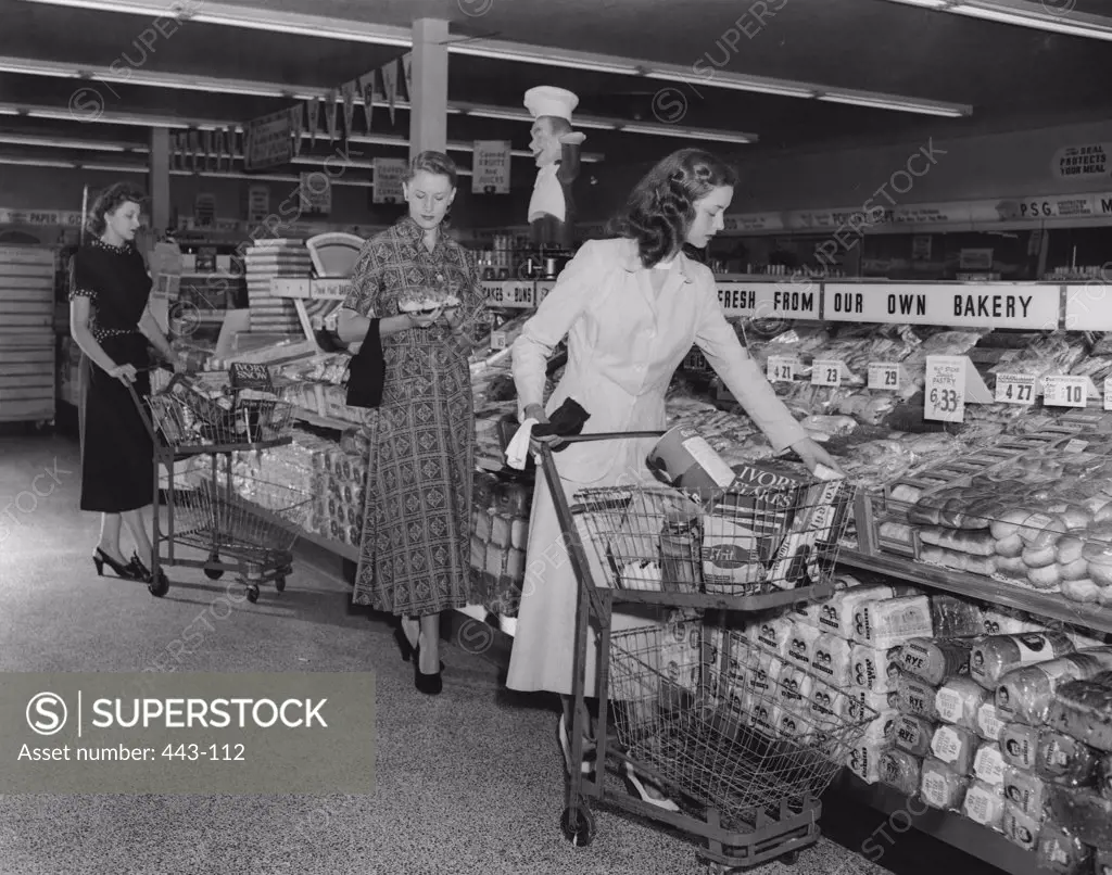 Three young women in a grocery store, Baltimore, Maryland, USA, 1949