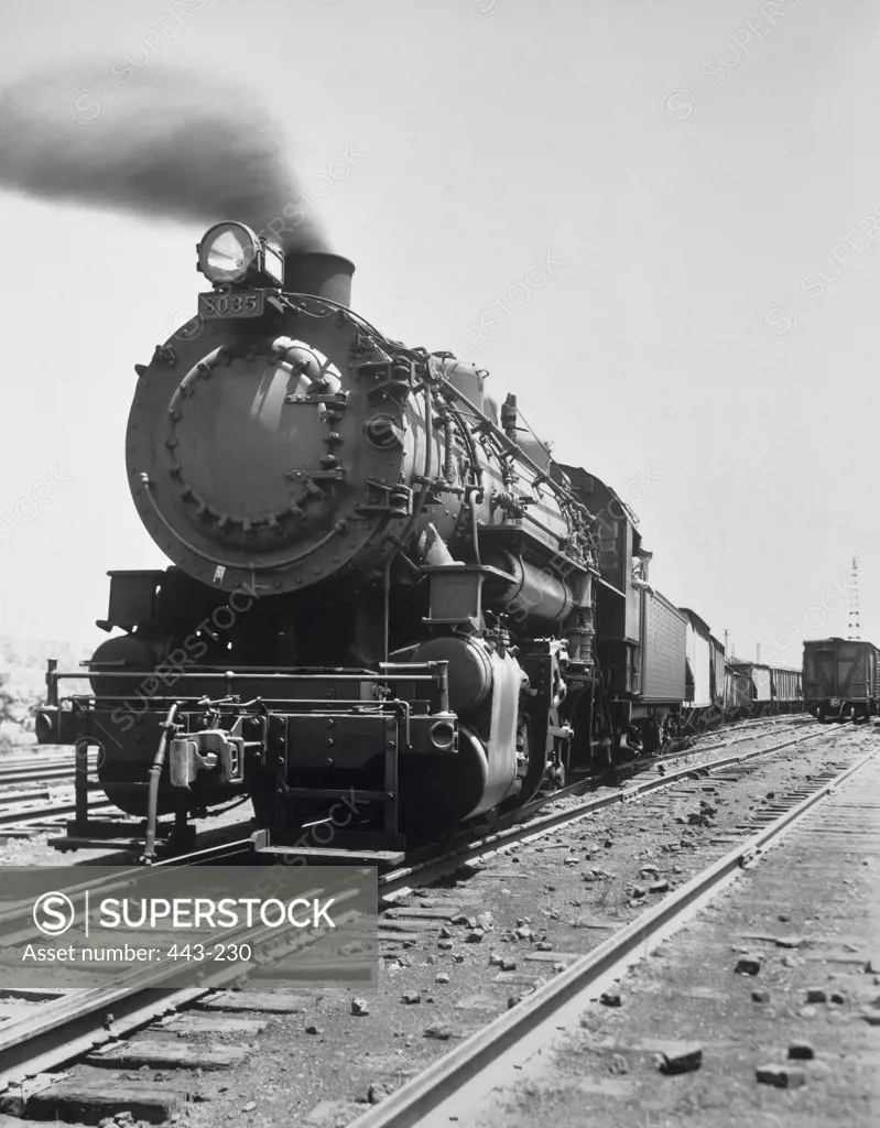 Steam locomotive on railroad track, 1941