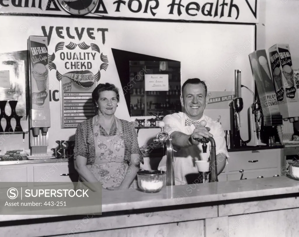 Portrait of a mature couple in a shop, 1951