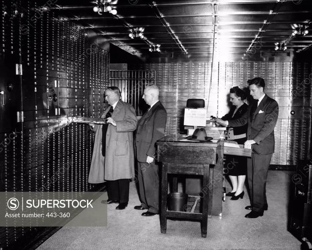 Four people in a safety box deposit room, 1942