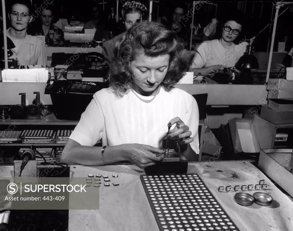 Young women performing quality control inspections in a factory