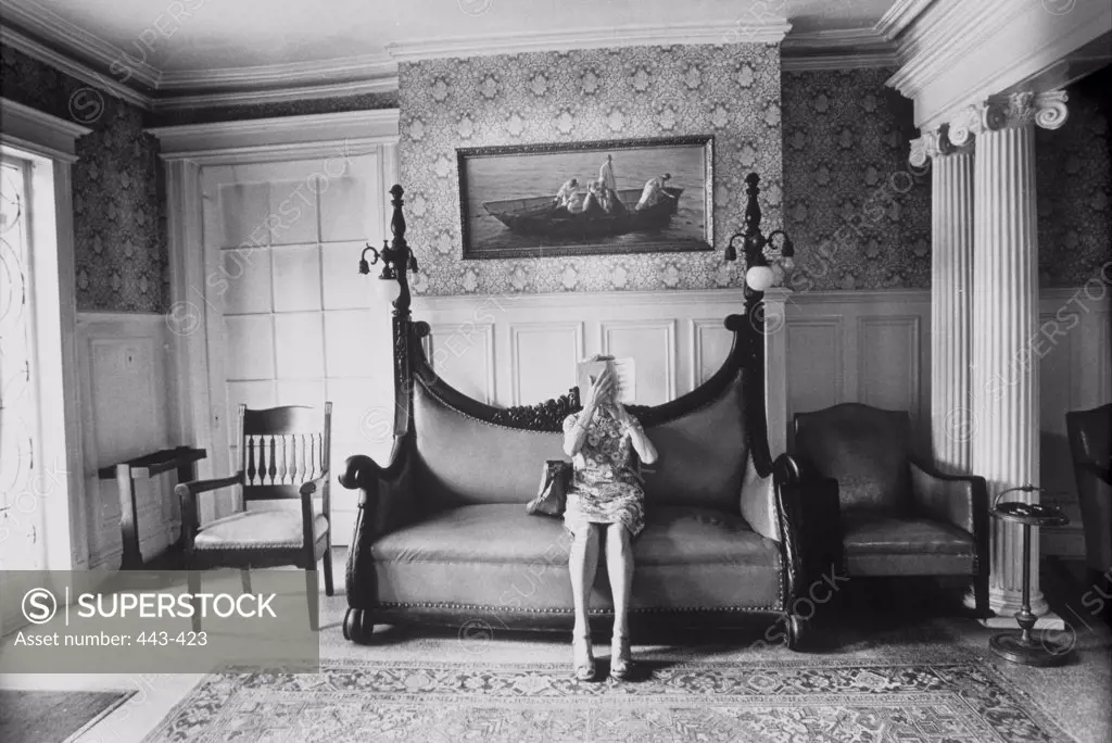 Senior woman reading a book in a living room