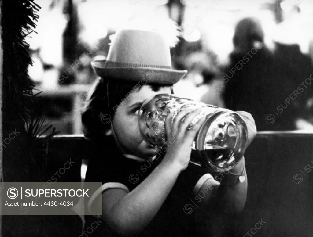 Germany Munich Oktoberfest child drinking from a stein late 1960s,