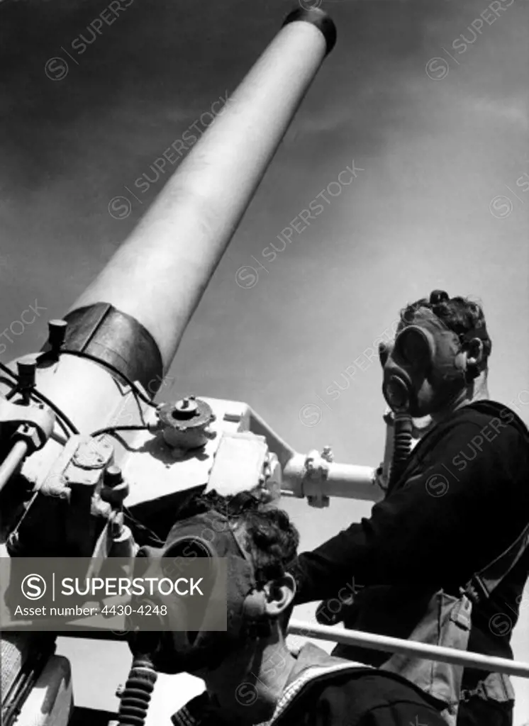 military Australia circa 1940 navy anti-aircraft gunnery drill artillerymen with gas masks on board of HMAS ""Canberra"" exercise in the Jervis Bay,