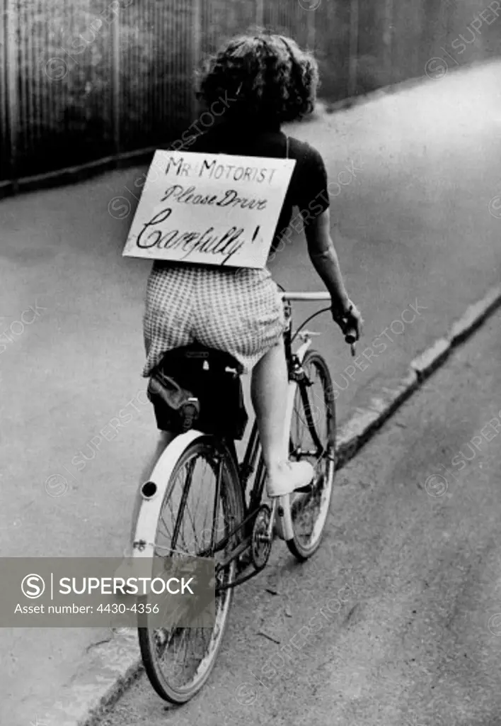 transport transportation bicycle woman with sign ""Mr. Motorist please drive carefully"" early 1950s,