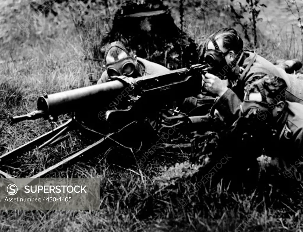 Nazism National Socialism military Wehrmacht army machine gun troop with heavy MG 08 and gas masks in firing position Infantry Regiment 106 Aschaffenburg area Germany late 1937,