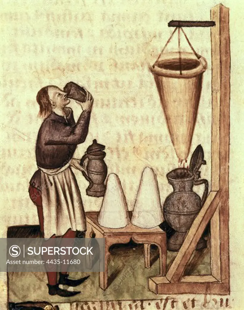Dioscorides, Pedanius (40-c.70). Greek physician. He settled down the scientific grounds of the medicine. Distilling alcohol. Illustration from 'Tractatus de herbis', edition from 15th century of the work 'De Materia Medica' by Dioscorides. Gothic art. Miniature Painting. ITALY. EMILIA-ROMAGNA. Modena. Estense Library.