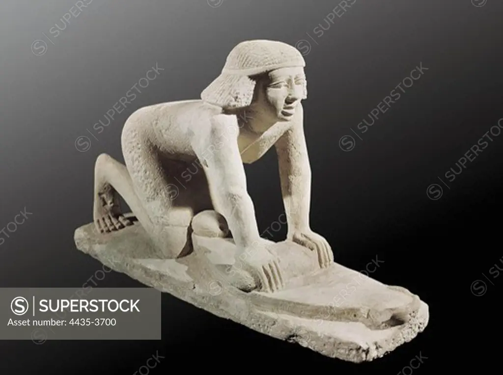 Model of a servant grinding grain. 2494 - 2345 BC. 5th Dynasty. Painted stone. Egyptian art. Old Kingdom. Sculpture on rock. EGYPT. CAIRO. Cairo. Egyptian Museum. Proc: EGYPT. CAIRO. Saqqara.