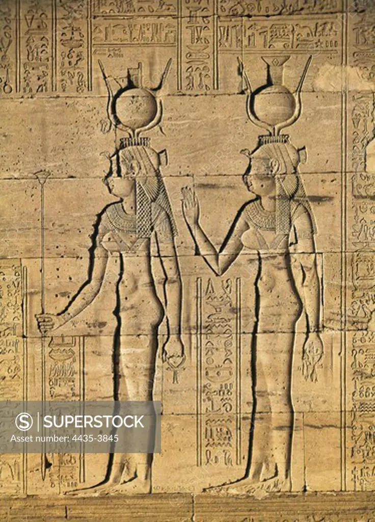 Temple of Isis. EGYPT. Philae. Temple of Isis. Goddesses Isis and Nephtis, sisters of Osiris. Bas-relief located on the northern outside wall of the sanctuary. Egyptian art. Ptolemaic period. Relief on rock.