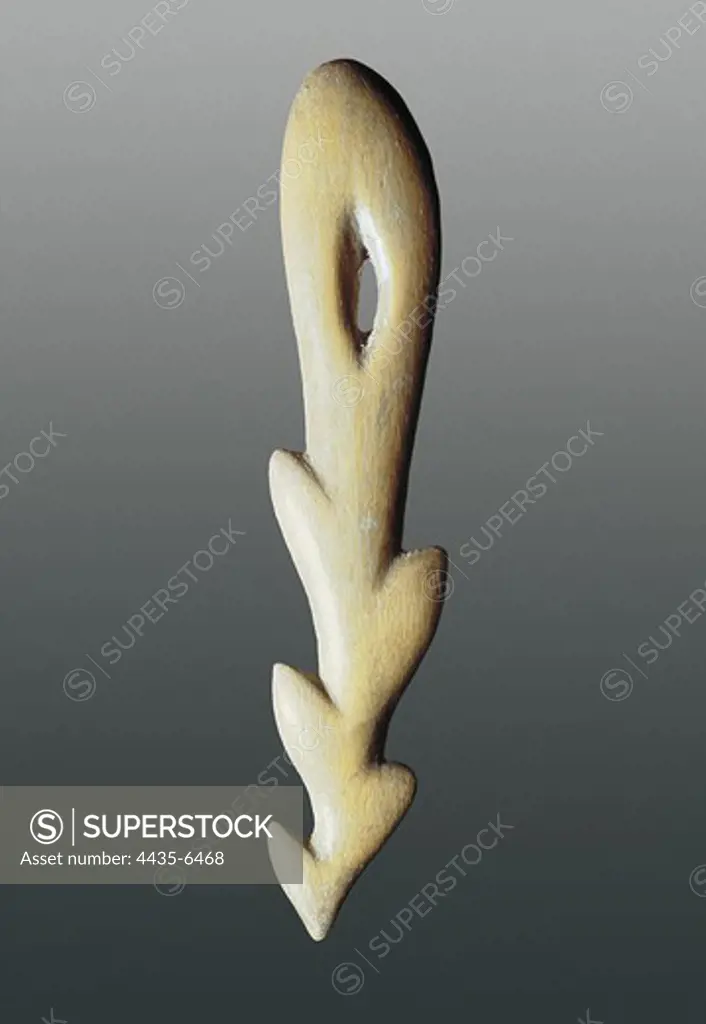 Bone harpoon. Upper Paleolithic. Magdalenian. Sculpture on ivory.