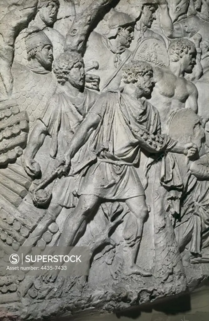 APOLLODORUS OF DAMASCUS (60-129). Column of Trajan. 110. ITALY. Rome. Forum of Trajan. First Dacian War. Third Campaign. 'Funditores' Balearic slingers. Auxiliaries troops of roman army. Roman art. Early Empire. Relief on rock.