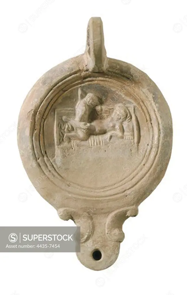 Voluted roman oil lamp with erotic scene. 1st c. A.D. Roman art. Early Empire. Terra-cotta. SPAIN. CATALONIA. BARCELONA. Barcelona. Archaeology Museum of Catalonia. Proc: SPAIN. CATALONIA. GERONA. L'Escala. Empœries.