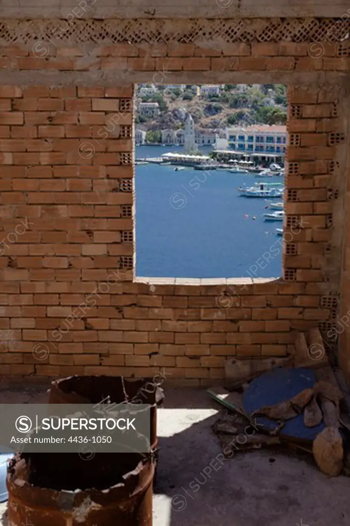 Greece, Island of Symi, Harbor seen through window of old house