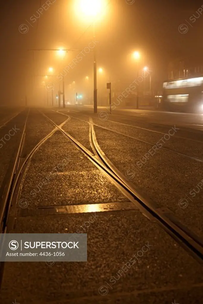 UK, Blackpool, Foggy tramlines at night