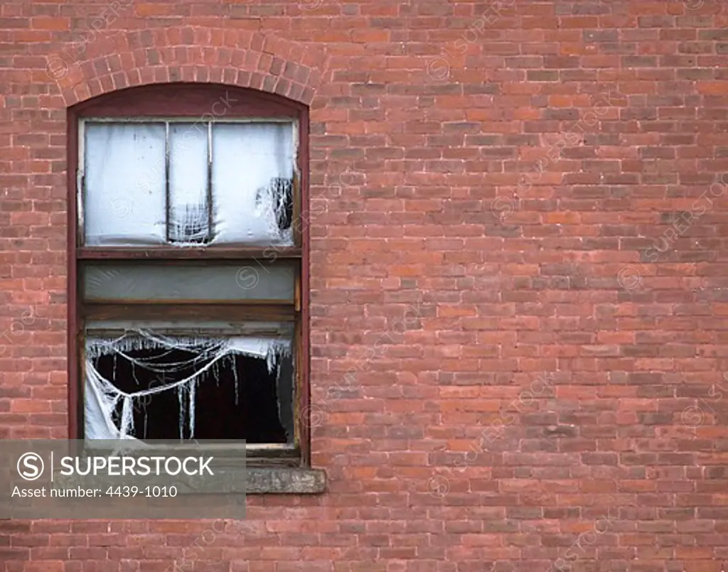 USA, Massachusetts, Montague, Tattered curtain in open window of abandoned building
