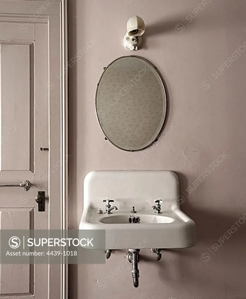 USA, Massachusetts, Franklin County, Old sink and mirror on wall in hotel