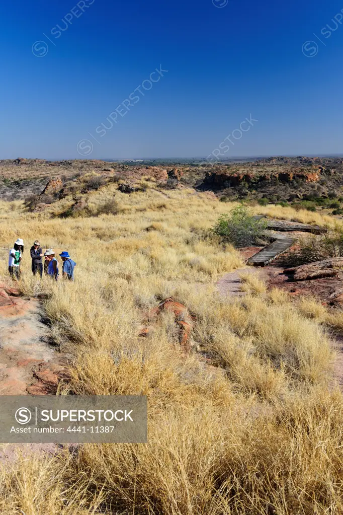 View from the top of Mapungubwe Hill. Tourists on a guided walk. Mapungubwe National Park. Limpopo Province. South Africa.