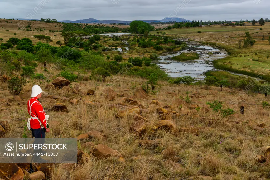 A British soldier looking at Rorke's (Rorkes) Drift accross the Buffalo River. KwaZulu Natal. South Africa
