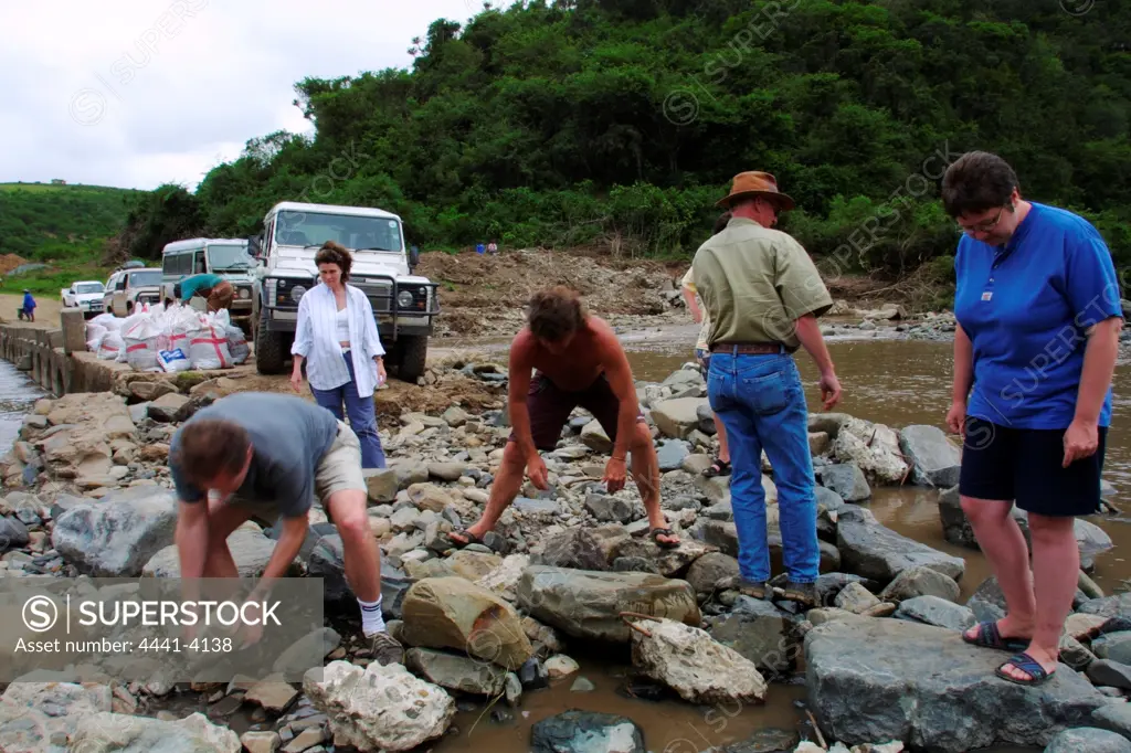 Tourists on African Coastal Adventures 4X4 trail building a road accross a river. Wild Coast. Eastern Cape. South Africa