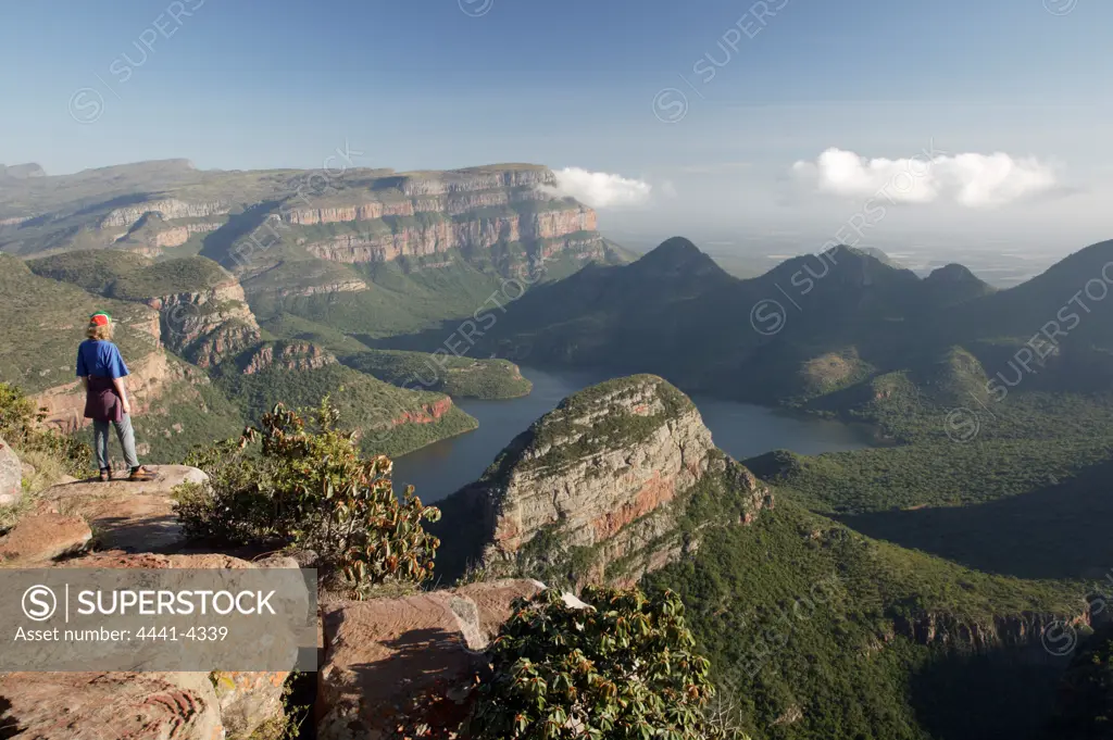 Tourist at Blyde River Canyon view site. View accross Blyde River Dam and into the lowveld. Mpumalanga. South Africa