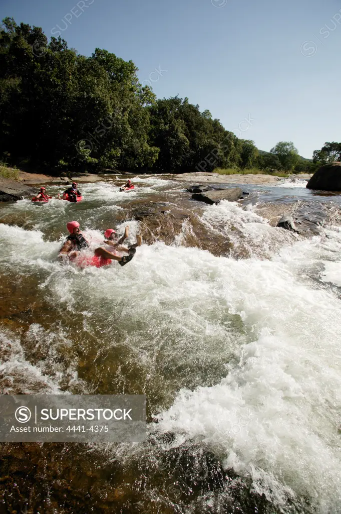 Tourists doing white water tubing in Sabi River. Hazyview. Mpumalanga. South Africa