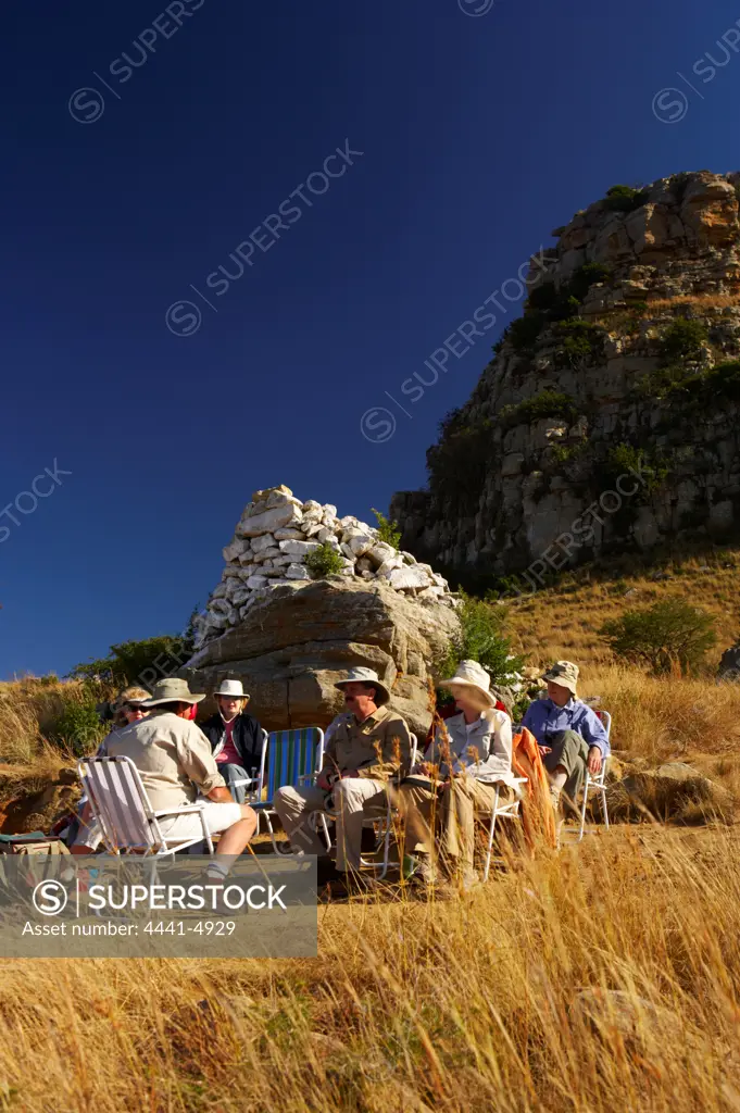 Dave Rattray with tourists on the side of the mountain at Isandlwana Battlefield. Near Nqutu. kwaZulu-Natal. South Africa.