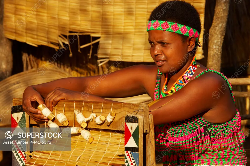 Zulu woman making a grass mat. Shakaland. Eshowe. KwaZulu Natal. South Africa