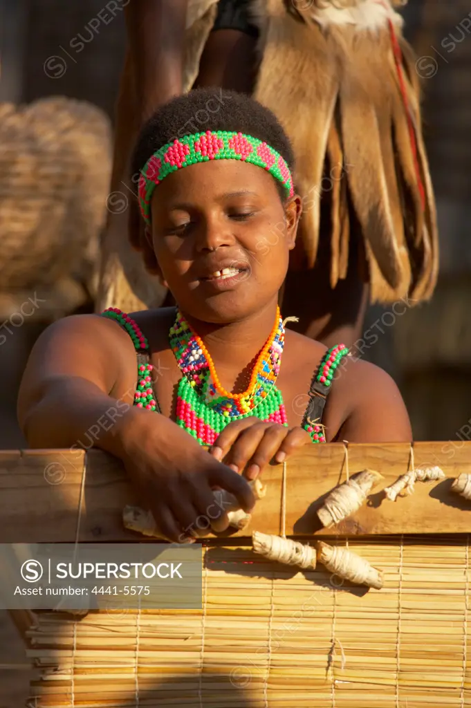 Zulu woman making a grass mat. Shakaland. Eshowe. KwaZulu Natal. South Africa