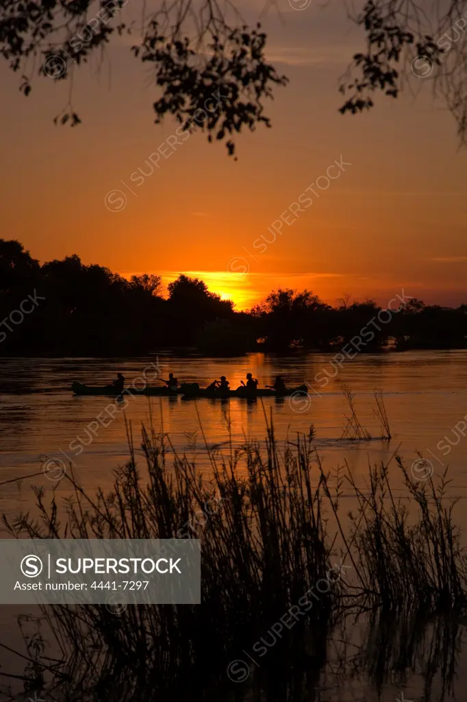 Canoe safari on Zambezi River at sunset. Victoria Falls. Zimbabwe