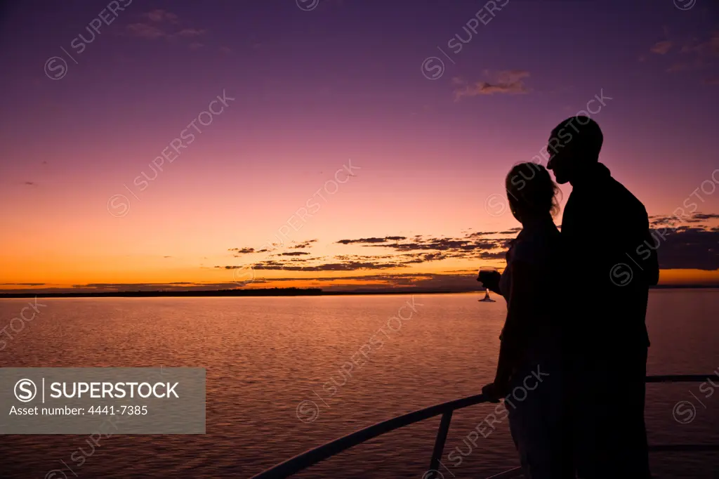 Tourists on board a house boat on Lake Kariba at sunset. Zimbabwe