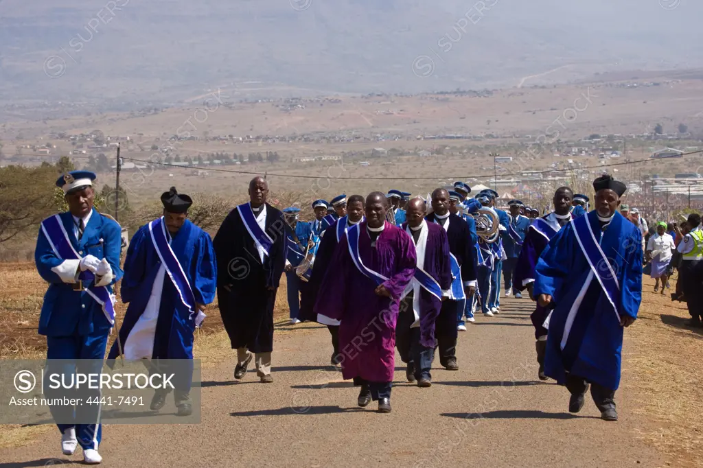 Clergy leading the mass of Zulu girls to the Palace at the Zulu Reed Dance. eNyokeni Royal Palace. Nongoma. KwaZulu Natal. South Africa