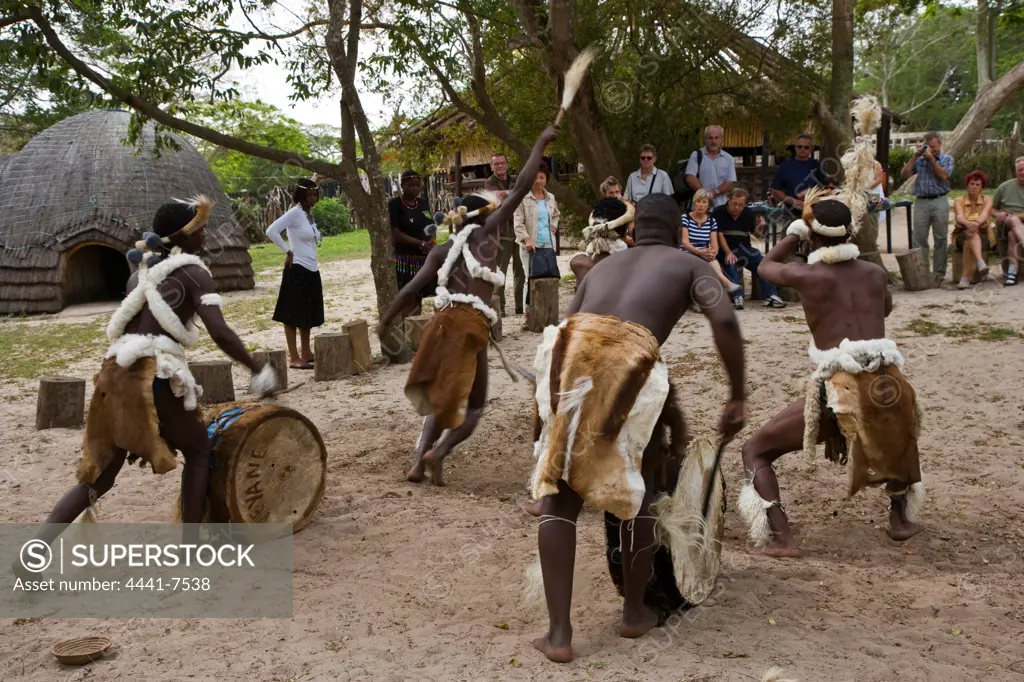 Tourists watching Zulu dancing at Veyani Cultural Village. St Lucia. Greater St Lucia Wetland Park or isiMangoliso Wetland Park. KwaZulu Natal. South Africa