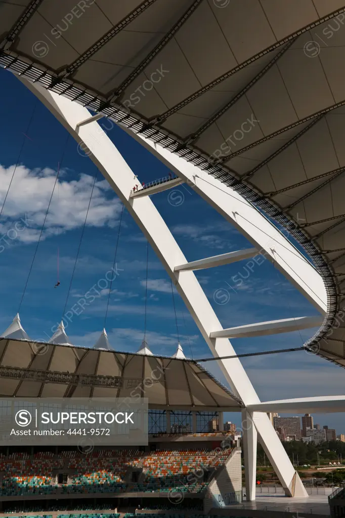 Person on the giant swing (type of bunji jump) from the arch of The Moses Mabhida Stadium interior detail. Durban. KwaZulu Natal. South Africa.