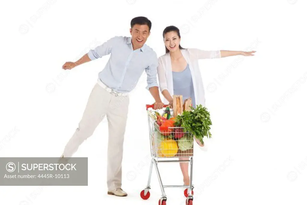 Young couple shopping with shopping cart