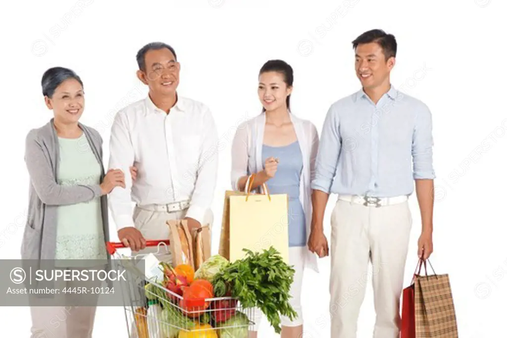 Senior couple and young couple shopping with shopping cart