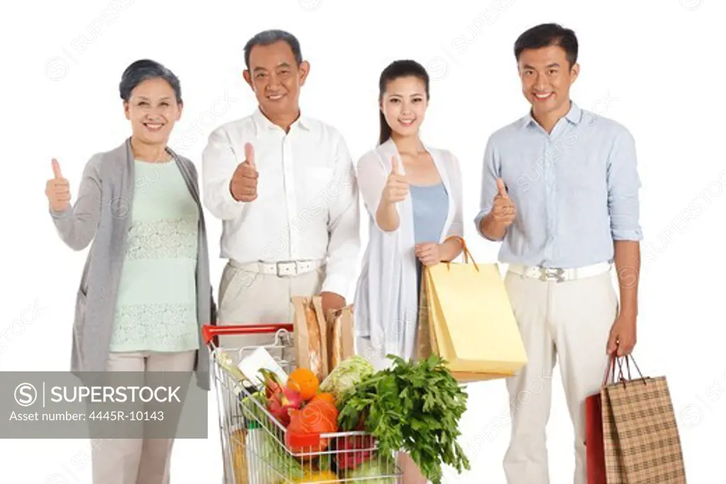 Senior couple and young couple shopping with shopping cart