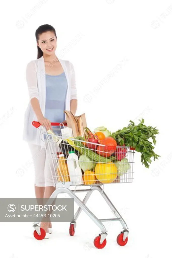Young woman shopping with shopping cart