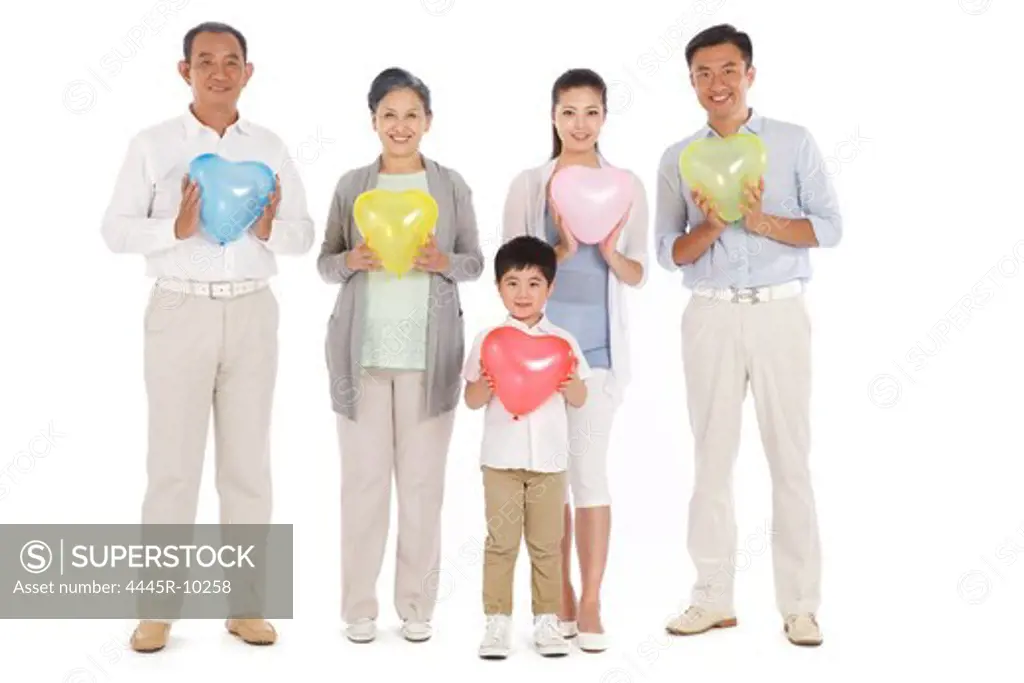 Whole family holding heart-shaped balloon