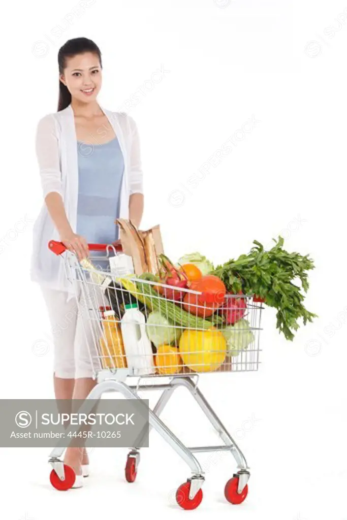 Young woman shopping with shopping cart