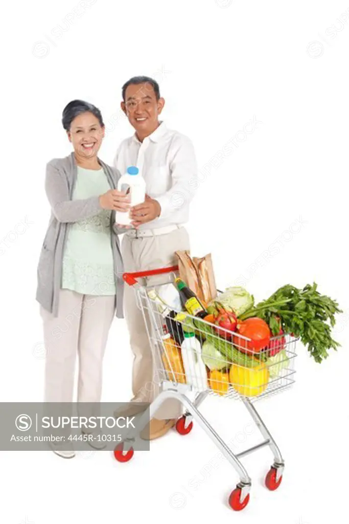 Senior couple shopping with shopping cart