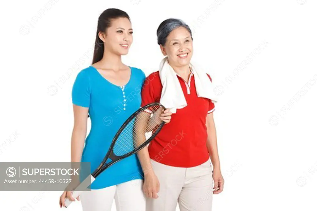 Mother and daughter holding racket