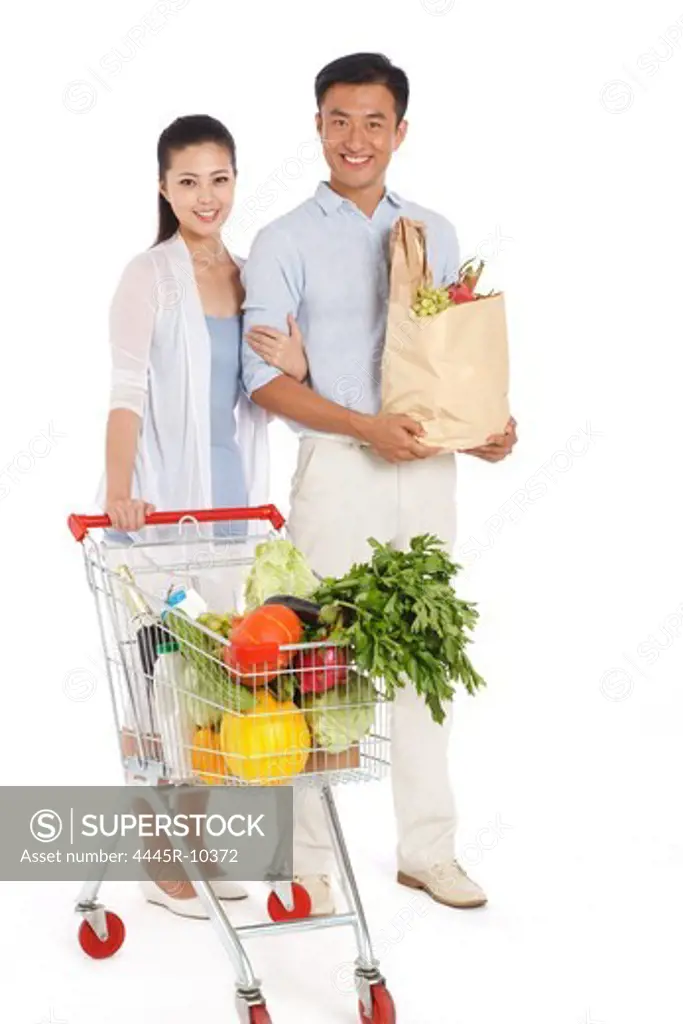 Young couple shopping with shopping cart
