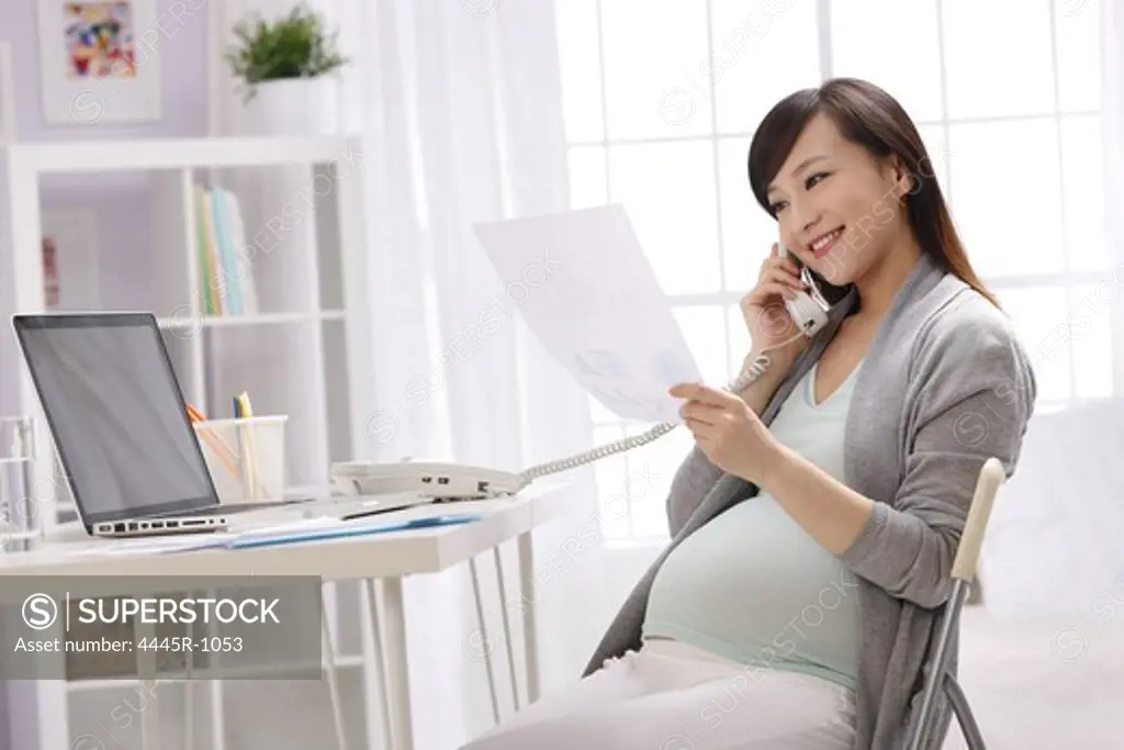 Pregnant woman calling by phone