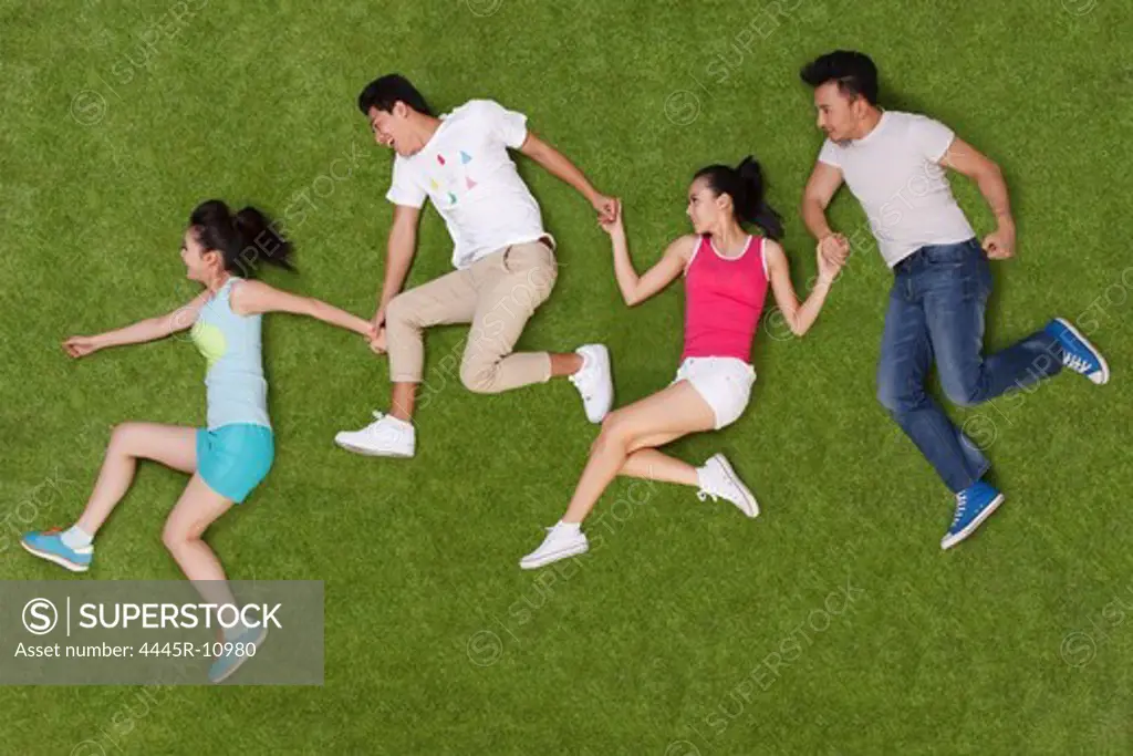Young people lying on grass