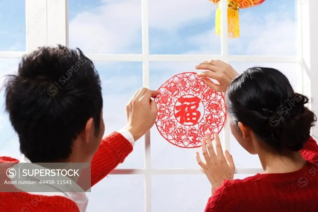 Young couple decorating on Chinese New Year