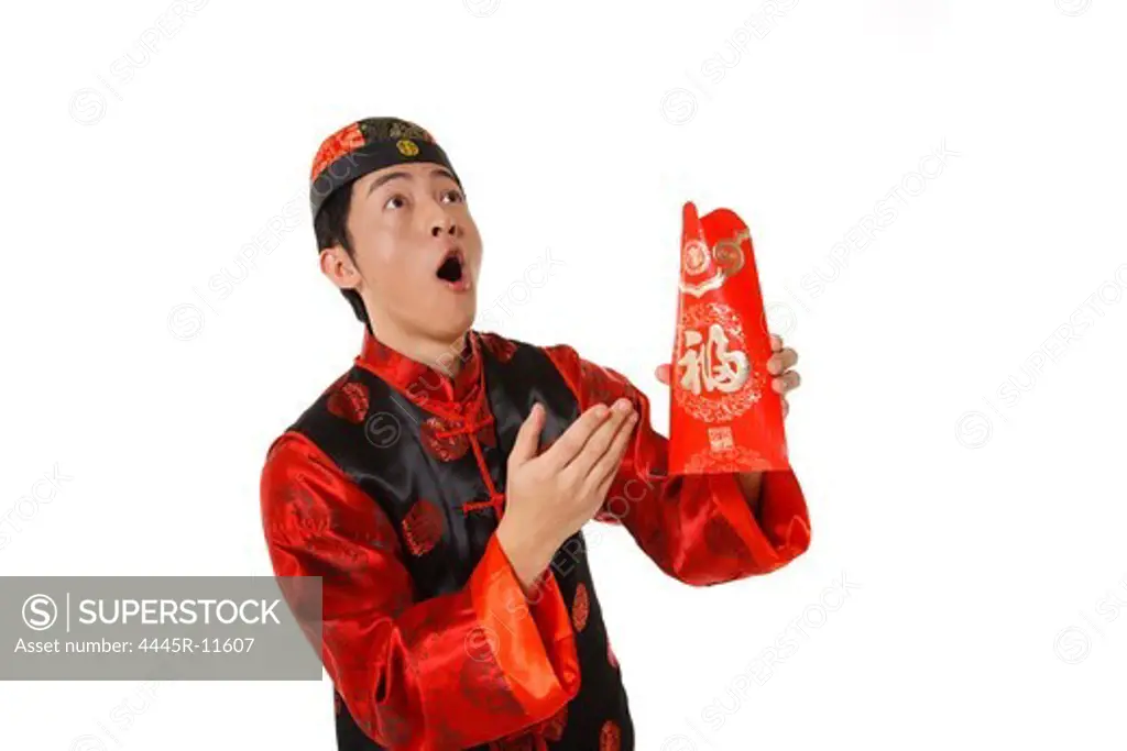 Young man holding red envelopes celebrating Chinese New Year