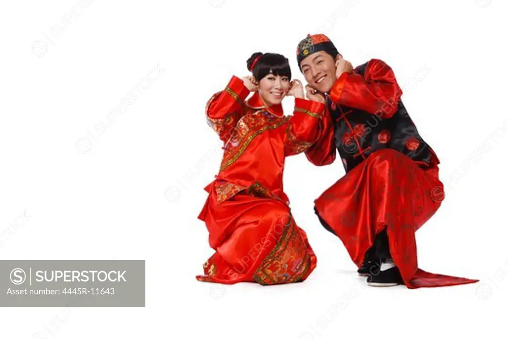 Young couple in traditional clothes with fire cracker